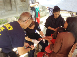 A RescueNet team treats an earthquake injury in a remote village